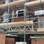 Scaffolding on the side of a building for loft insulation.