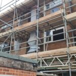 Scaffolding on the side of a building for loft insulation installers.