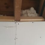 A room with a white ceiling and a piece of spray foam insulation.