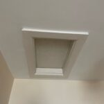 A small window in the ceiling of a room, also known as a loft hatch.