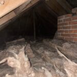 An attic with a lot of insulation and loft boarding.