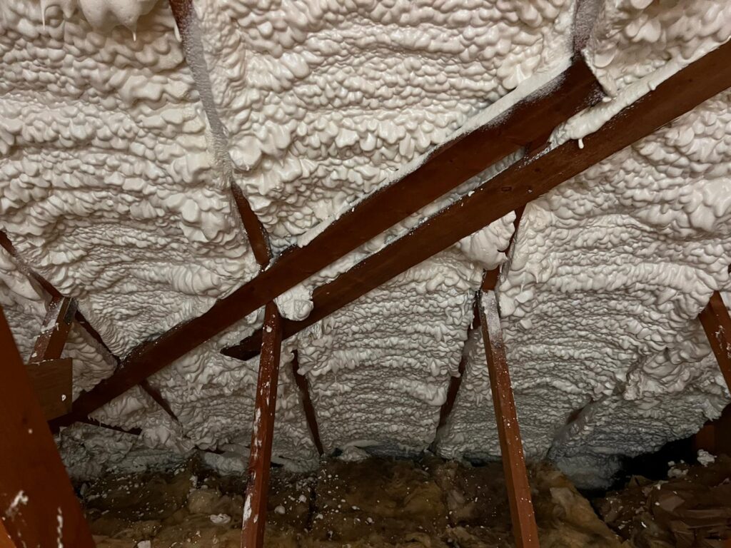 The ceiling of a house is covered with white loft insulation.