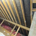 An attic with *insulation* and *loft insulation installers* being installed.