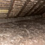 An attic with a lot of insulation installed.