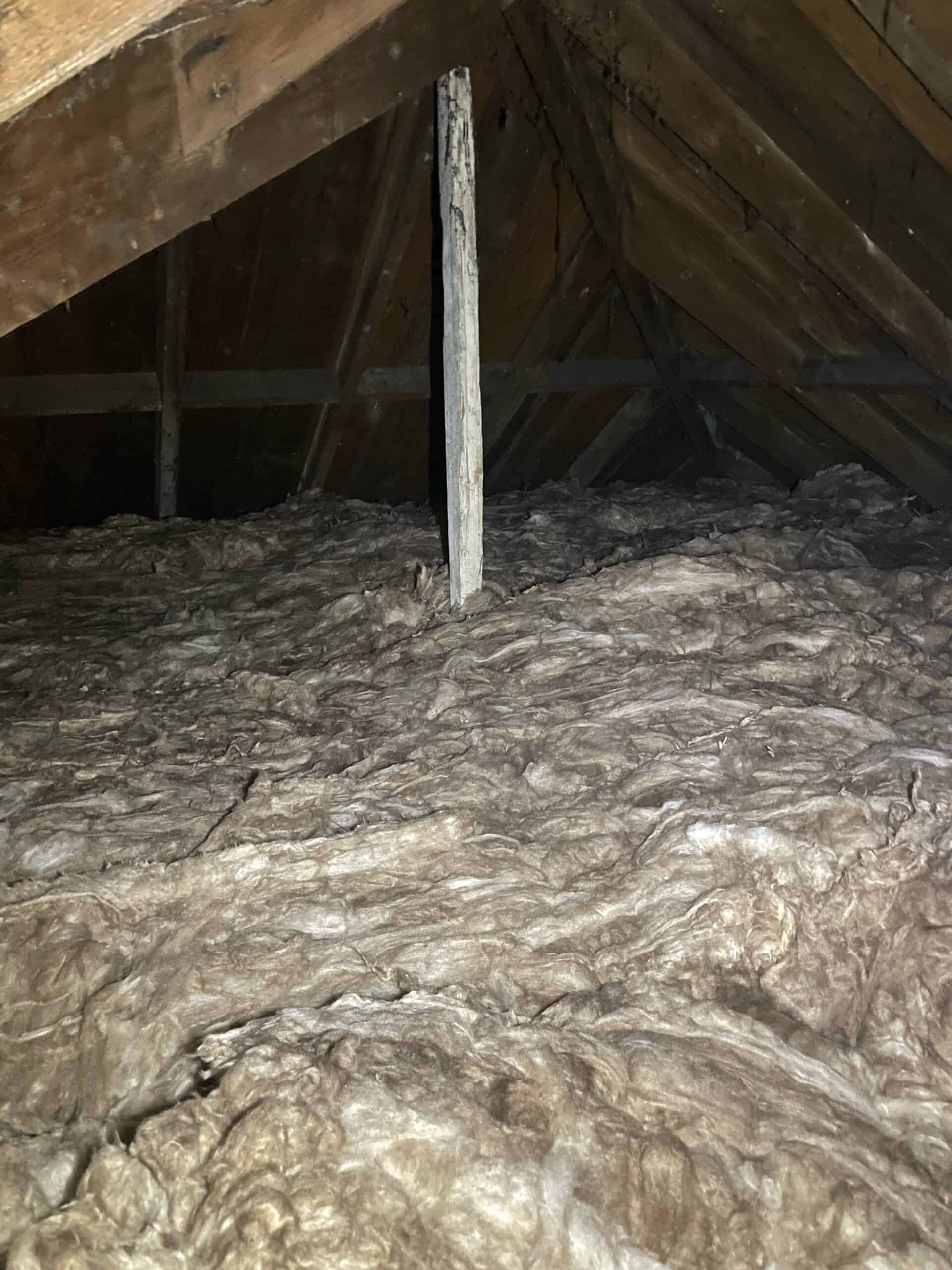 Loft insulation with mineral wool installed between roof rafters for energy efficiency.