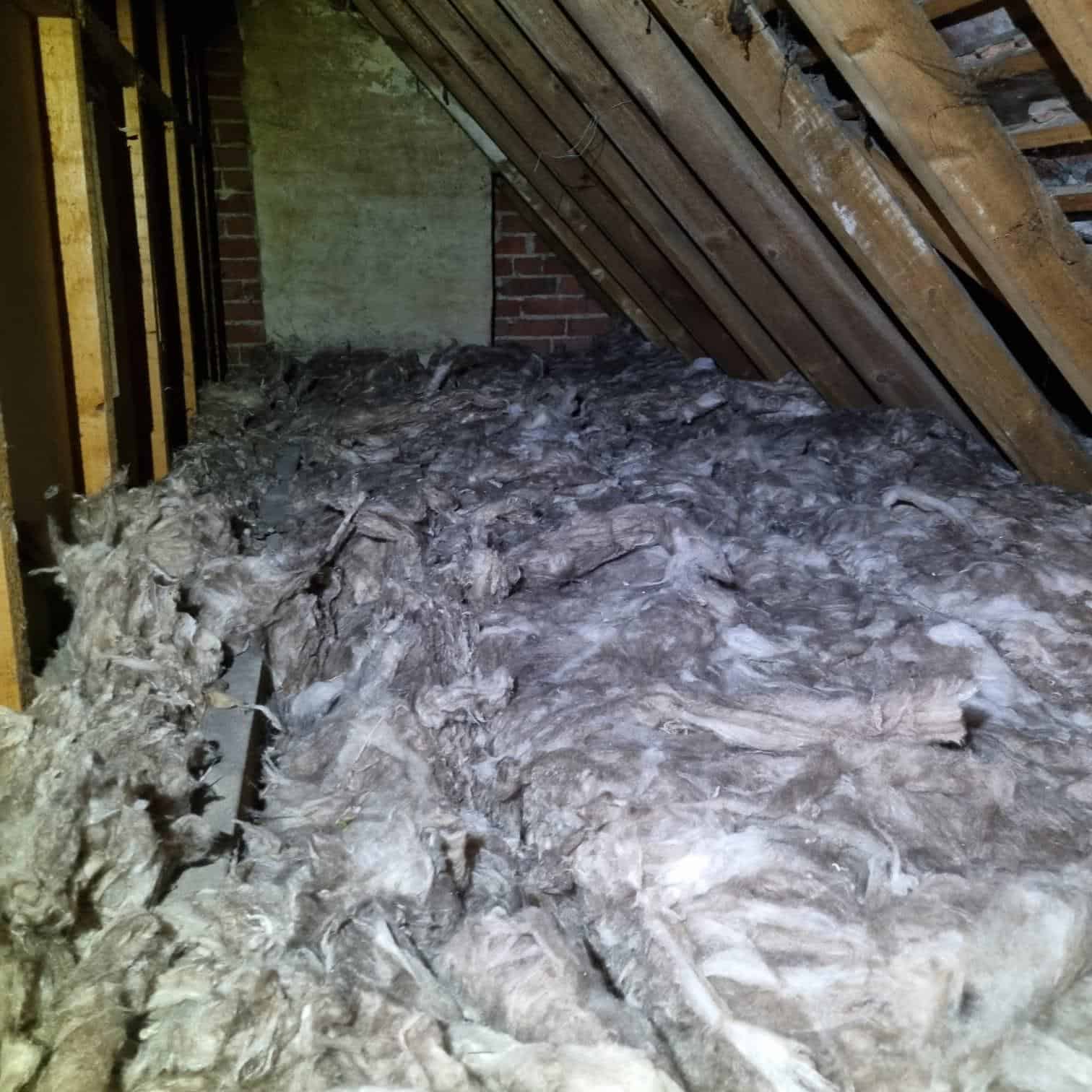Attic loft insulation with mineral wool installed between rafters, improving energy efficiency and r.