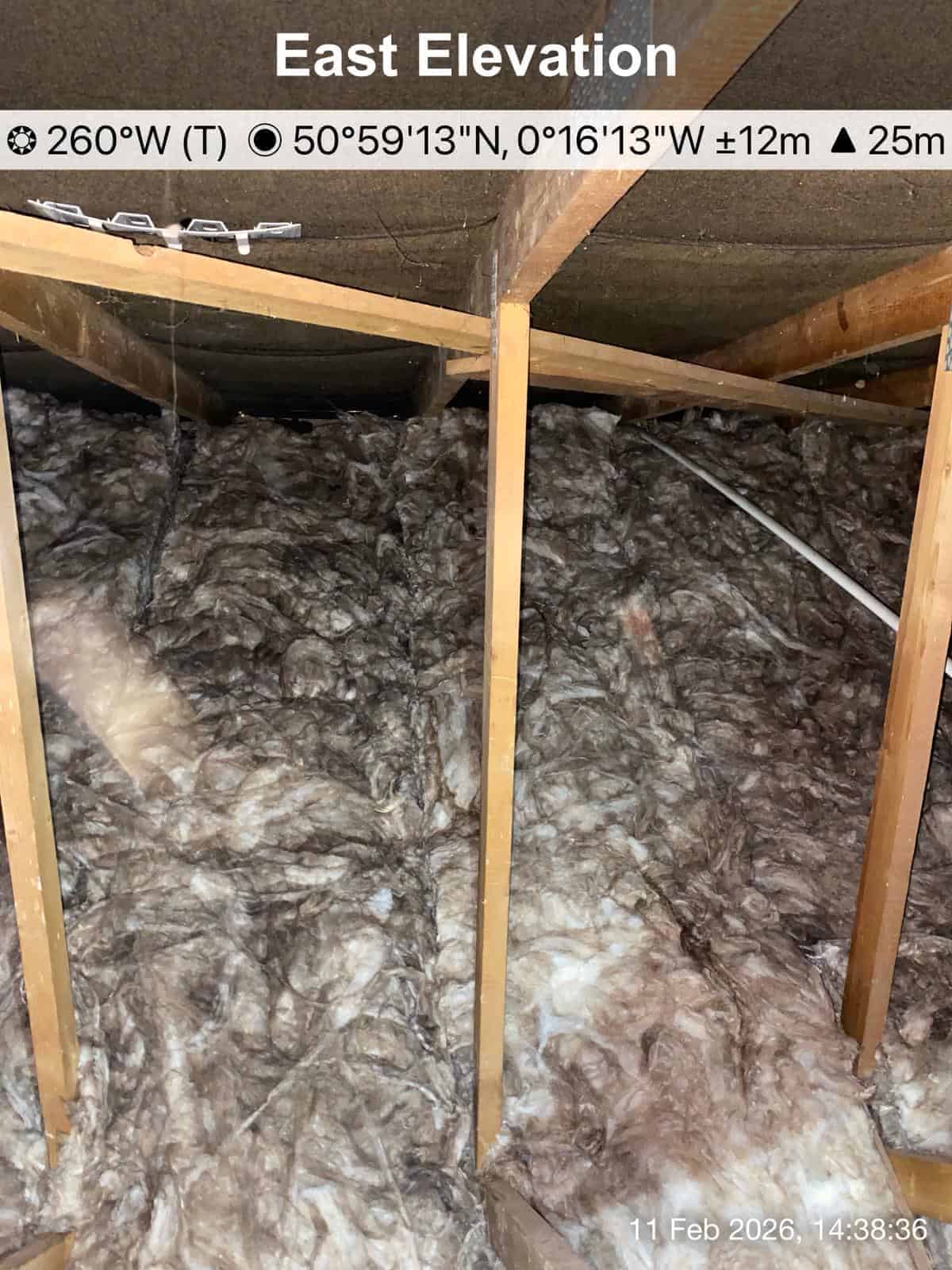 Loft insulation installed between joists in an attic space.