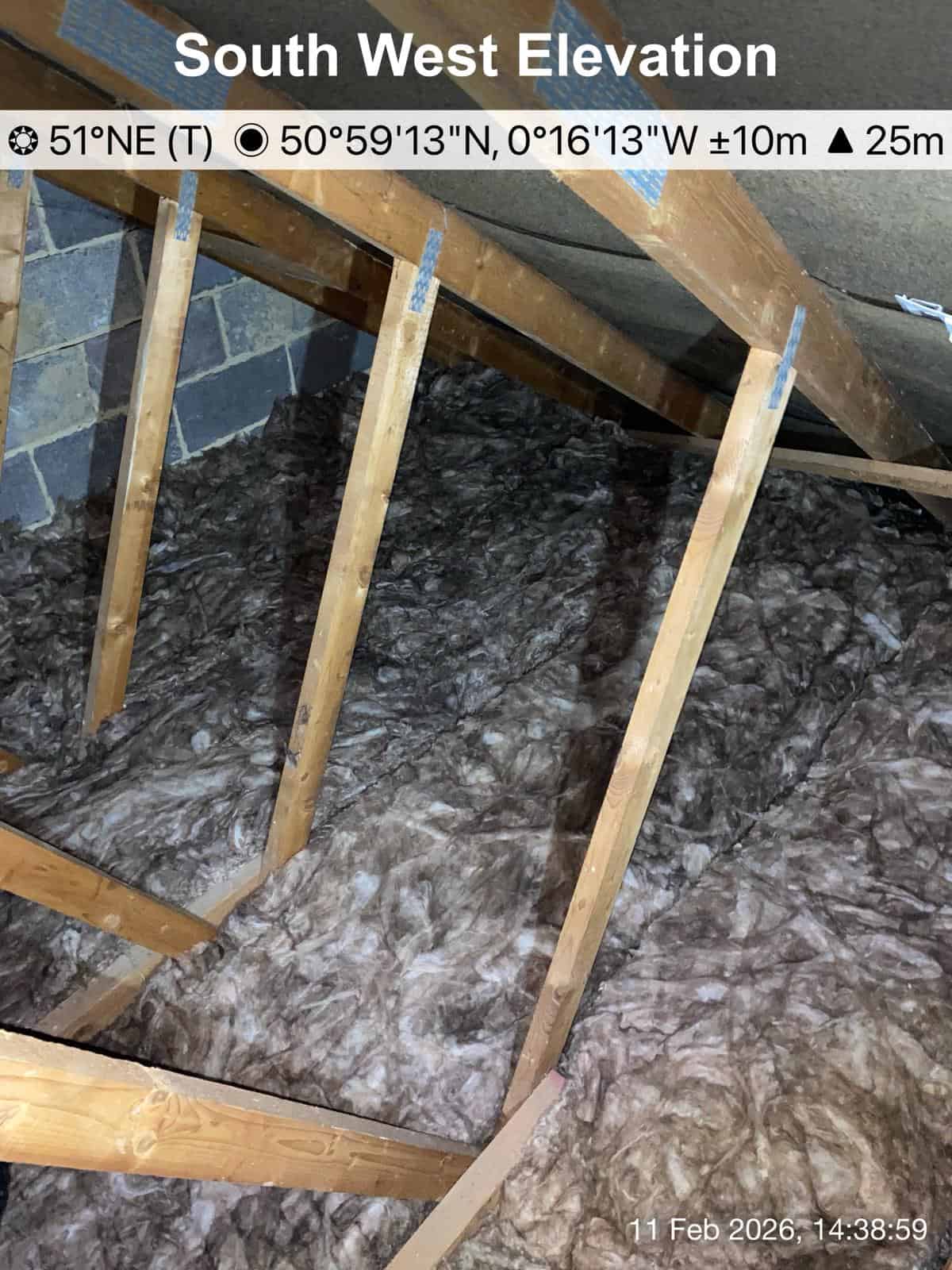 Loft insulation installed between floor joists for energy efficiency.