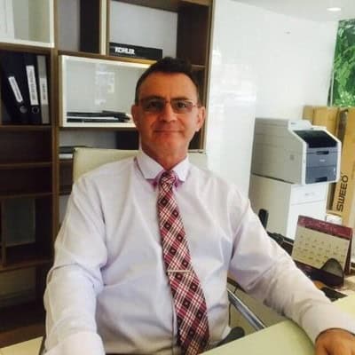 Professional man in office, promoting insulation services.