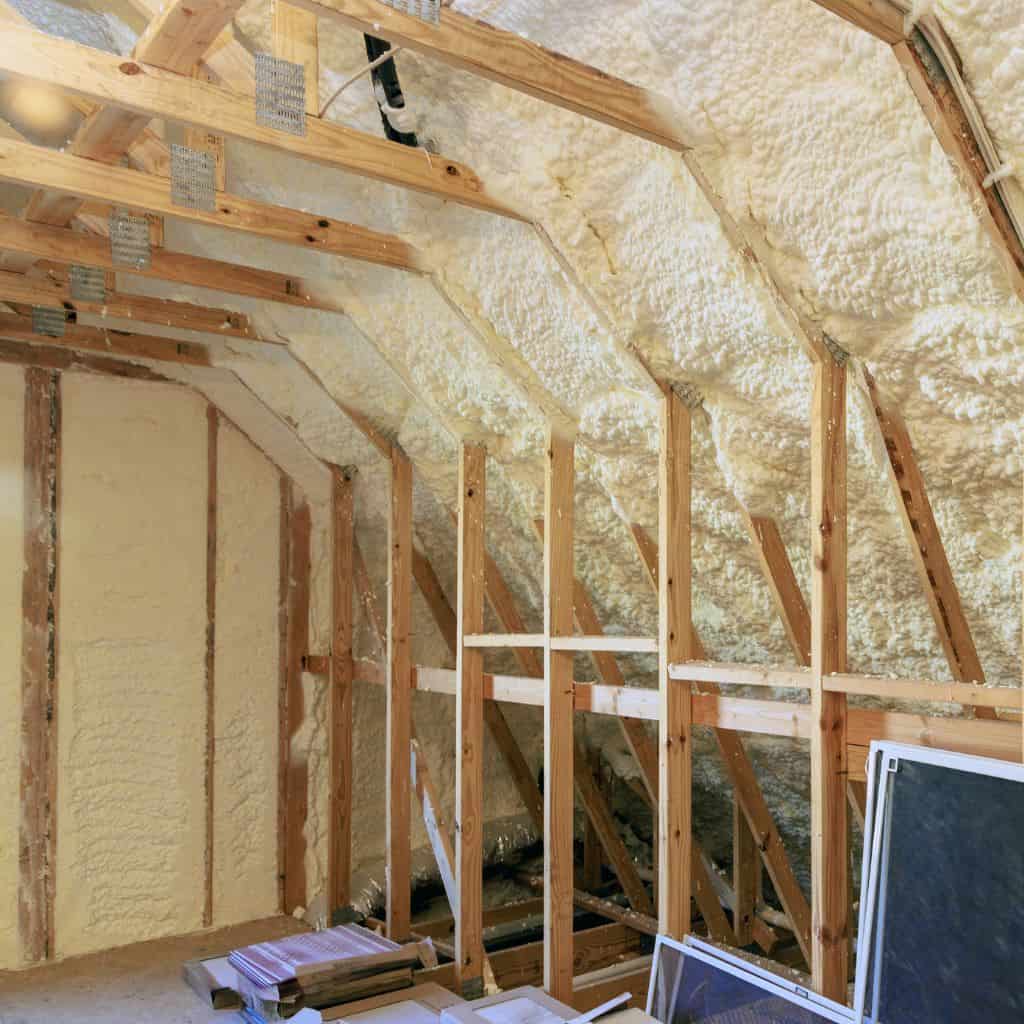 Spray foam insulation being removed from a loft space.