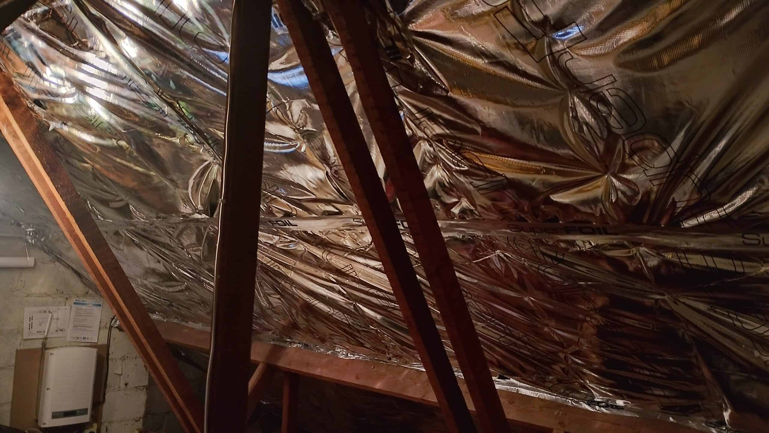 Loft insulation with superfoil insulation material in attic space.