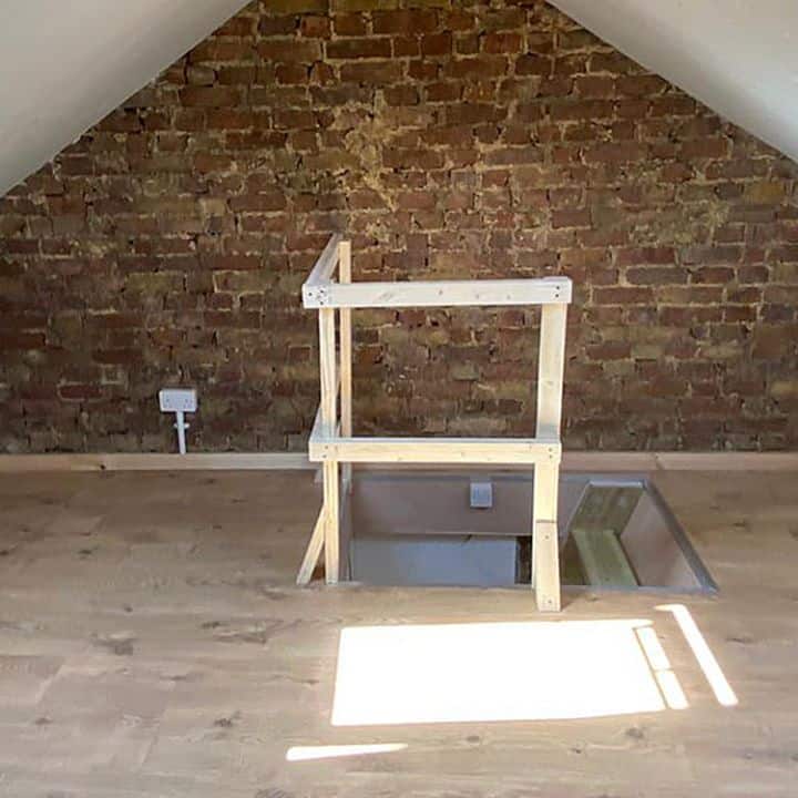 Wooden balustrade in an attic space to support loft hatch opening