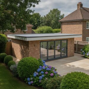 Contemporary garden room with large glass doors and flat roof in a landscaped garden.
