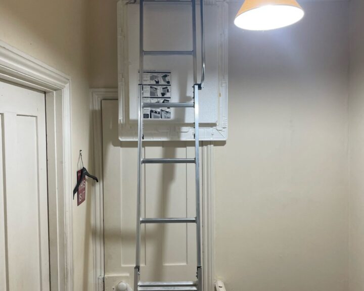 A ladder in a room with a light on it, ideal for loft insulation.